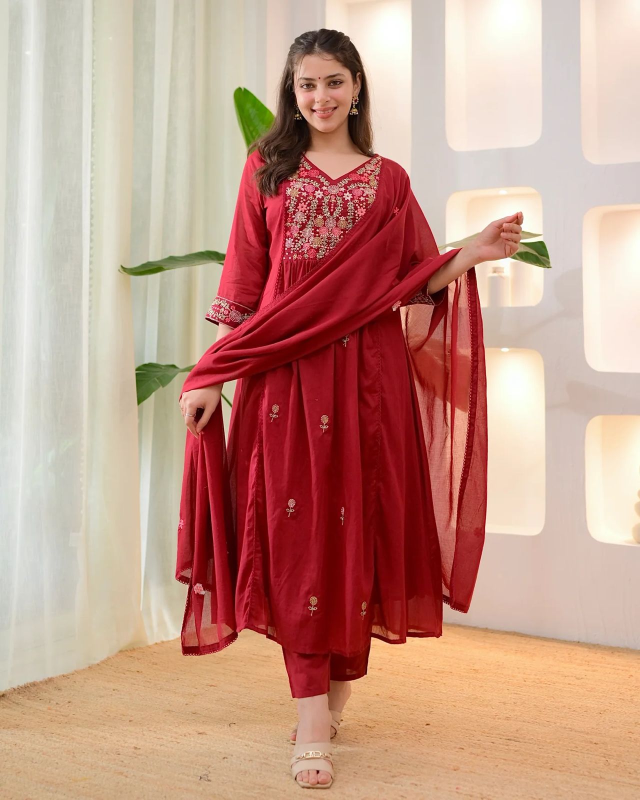 Gulab Threadwork A Line Mul Cotton Suit featuring intricate thread embroidery and a flowy design in a vibrant red color.