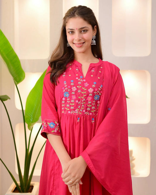 Baag Threadwork A Line Mul Cotton Suit model wearing pink dress with floral embroidery in elegant setting